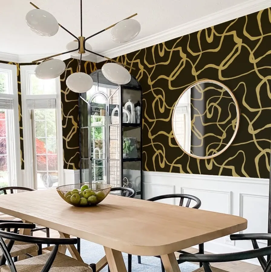 Dining room with modern black and gold metallic wallpaper