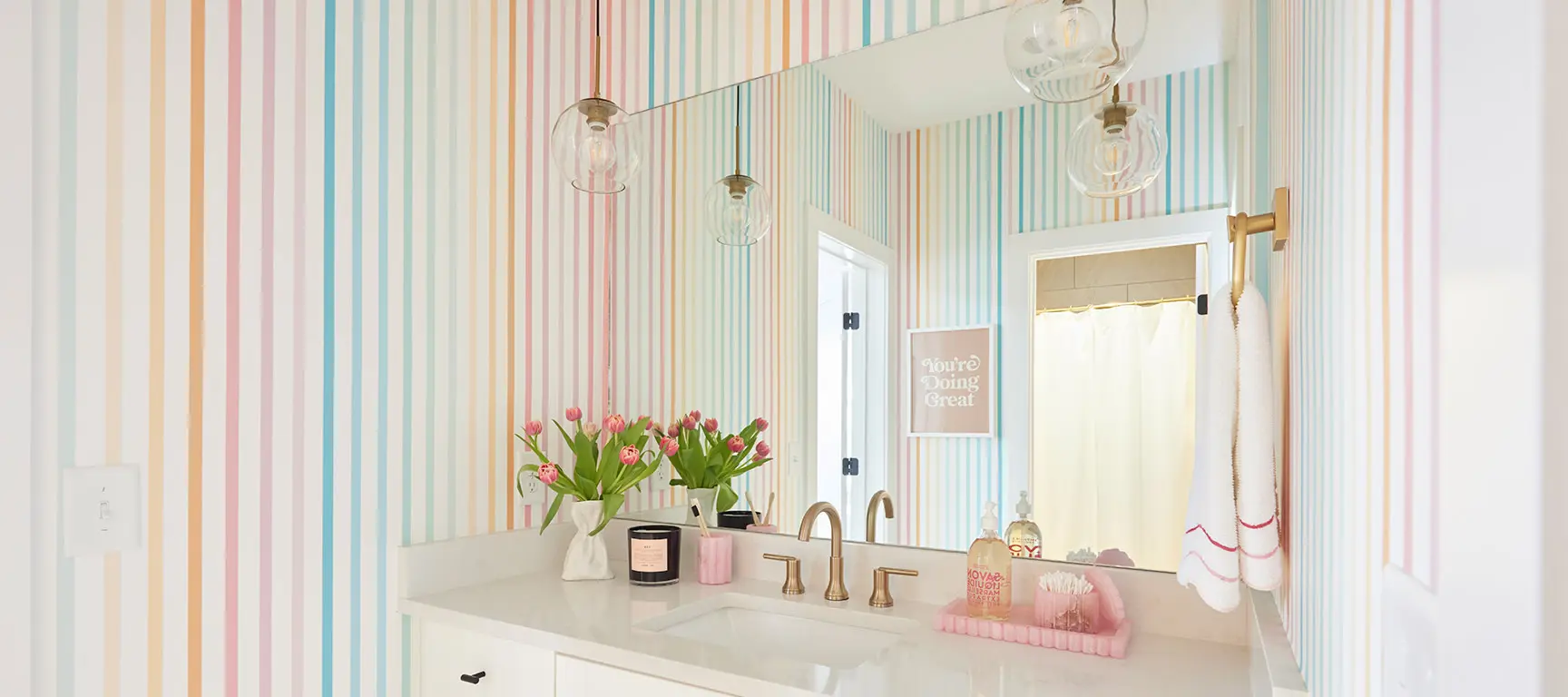Rainbow striped wallpaper in a bathroom.